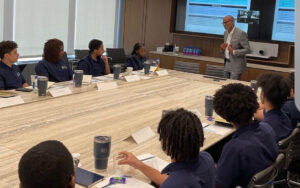 Students sitting around a conference table at HPS Center for Financial Excellence.