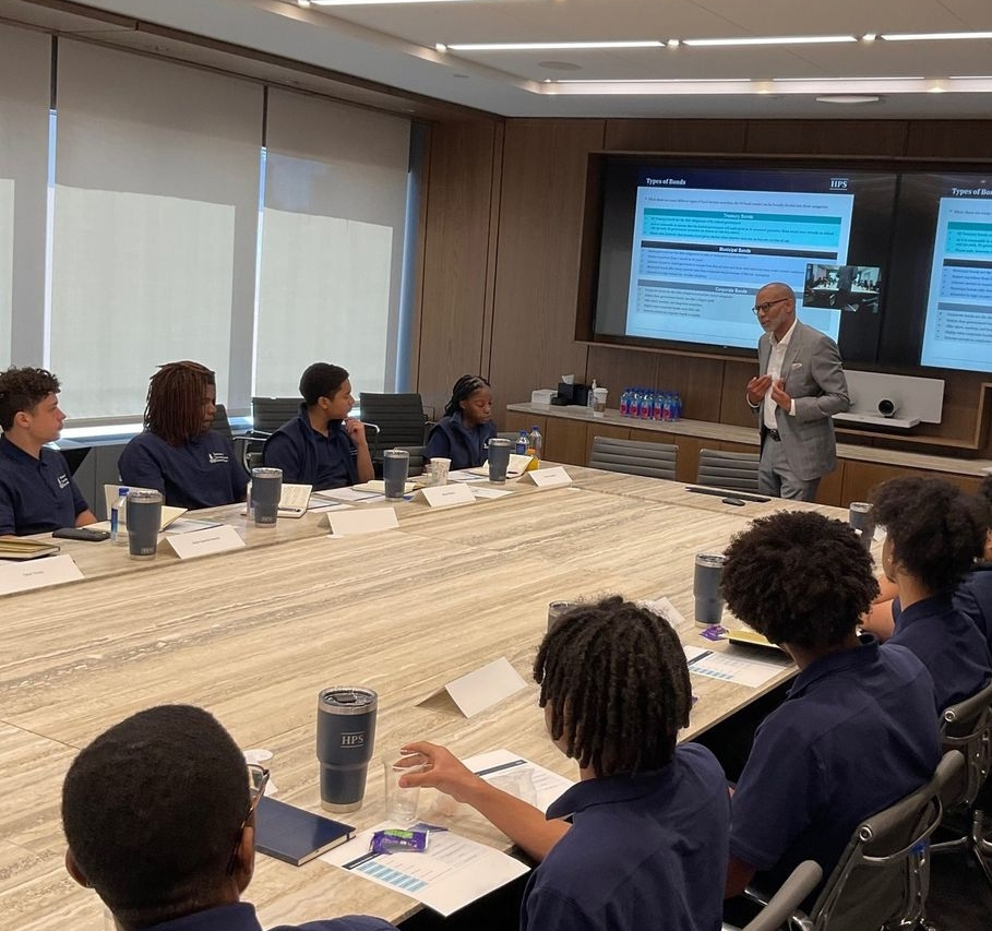 Students sitting around a conference table at HPS Center for Financial Excellence.