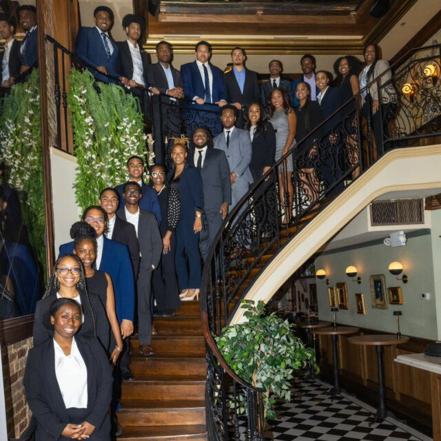 Howard students standing along a curved staircase.